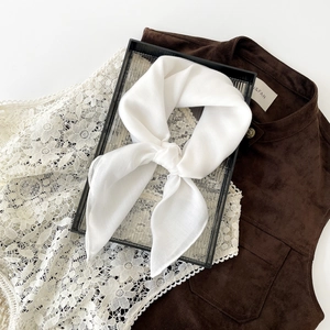 Detail of white cotton linen square headscarf with herringbone texture and soft silk feel