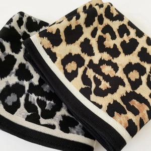 Fashionable leopard print triangle shawl with twill texture and contrast stripe borders