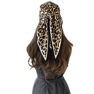 Fashion leopard print silk scarf styled as a stylish headscarf with black and white borders