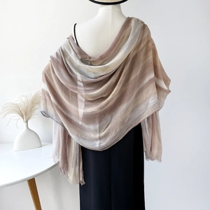 Close-up of lightweight gradient cotton scarf with subtle fringe trim on a mannequin