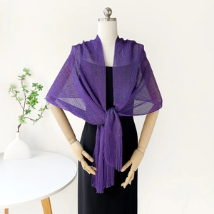 Close-up of purple knit shawl with long tassels and hollow metallic mesh texture