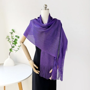 Detail of purple mesh shawl with tassels on white mannequin for evening dress