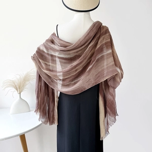 Detail of coffee and beige gradient tie-dye shawl featuring delicate fringed edges