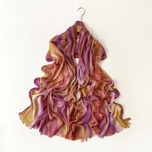 Detail showing the pleated fabric texture and purple-yellow gradient of the scarf