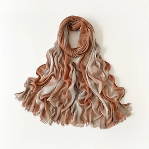 Detail of crinkled viscose scarf with orange and grey gradient stripes and fringe
