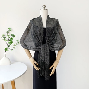 Detail of black shimmering shawl with elegant fringe tassels for evening party dresses