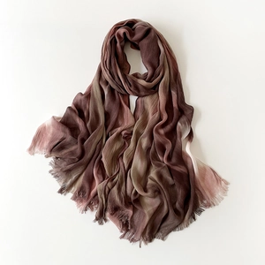Detail of gradient pashmina shawl with tassel fringe in brown and olive green tones