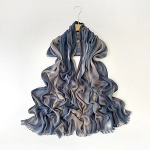 Detail of crinkled gradient shawl in dark blue and taupe with delicate fringe edges
