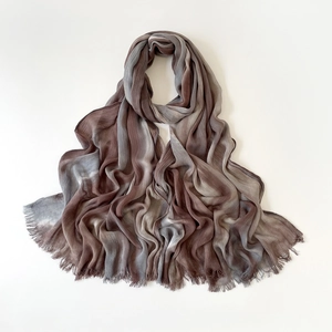 Macro detail of gradient brown linen scarf showing textured fabric and fringed edges