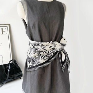 Seidenschal mit Zebramuster als stilvoller Gürtel an einem grauen Kleid gebunden
