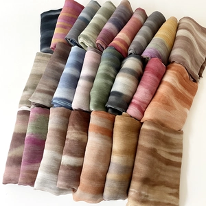 Gradient blend beach scarf for women in various colors shown in a flat lay display