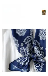 Detail of navy blue silk-like square scarf featuring white paisley and mandala patterns