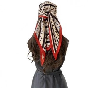 French vintage beige silk scarf with red horse equestrian pattern worn as a headscarf