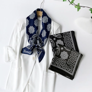 Detail of vintage geometric flower patterns on satin silk scarves with a glossy finish