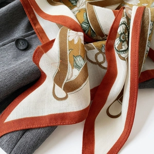 French vintage orange floral silk scarf with equestrian print on gray suit blazer