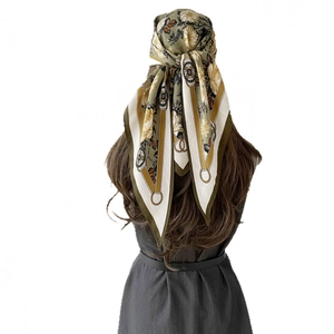 French vintage triangle silk scarf with retro floral and clock patterns worn as a headscarf