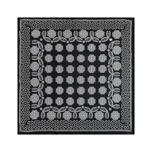 Macro detail of square satin scarf showing black and white mandala flower pattern
