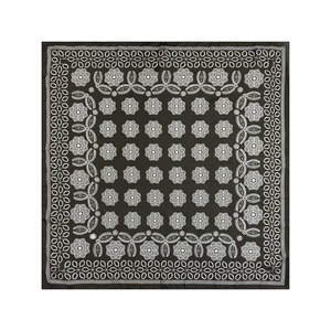 Detail view of the bohemian black and white floral pattern on a square silk-like scarf