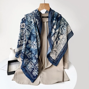 Detail of navy blue cashew print scarf draped over a beige blazer for office wear
