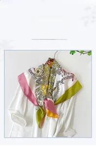Detailed view of floral satin silk scarf tied on a white blazer with French pattern design