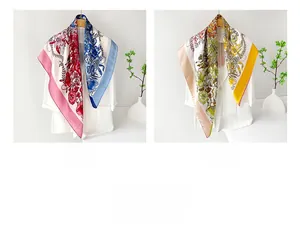 Detail view of floral satin square scarves in pink-blue and yellow-green silk textures