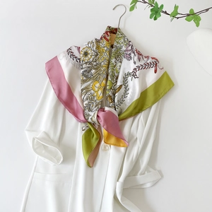 Detail of floral silk scarf styled with a white blazer for an elegant fashion look