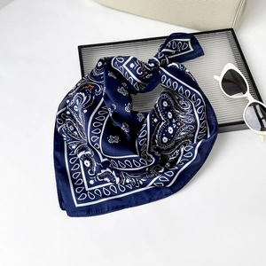 Close-up of navy blue paisley silk scarf with satin finish and fine stitched edges
