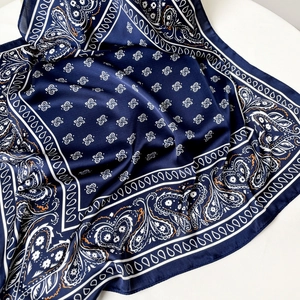 Navy blue paisley silk scarf with white floral patterns and geometric border design