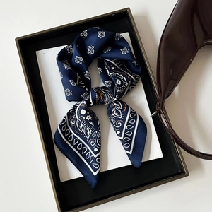 Navy blue paisley satin square scarf tied in a bow with vintage floral patterns