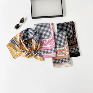Close-up of silk-like houndstooth and baroque print square scarves in various colors