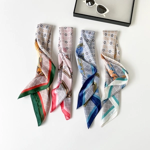 Detail of four colorful satin twilly scarves with geometric patterns and silk-like sheen
