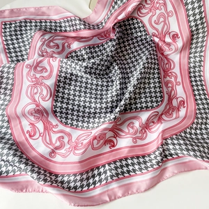 Detail of pink houndstooth square scarf with baroque patterns and silk texture