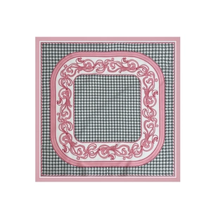 Detailed pattern of houndstooth and baroque scrolls on silk-like square neck scarf