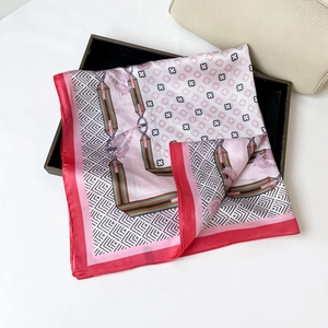 Detailed view of elegant four-leaf clover print satin square scarf in pink and white
