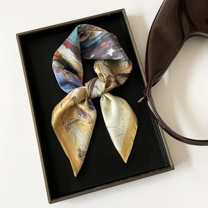 Close-up of abstract oil painting floral print silk scarf with satin luster and smooth texture