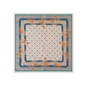 Macro detail of elegant four-leaf clover print and vintage chain patterns on square silk scarf