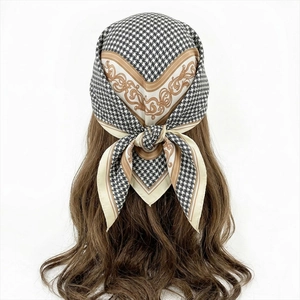 Houndstooth and paisley print silk-like square scarf styled as a headband on mannequin