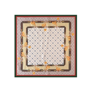 Detail of satin square scarf featuring four-leaf clover print and gold chain motifs