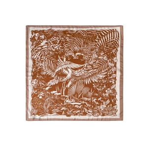 Macro detail of French forest print silk scarf featuring tropical leaves and bird patterns