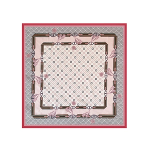 Close-up of elegant silk-like square scarf with clover print and chain pattern details