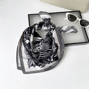 Elegant black and white floral silk scarf with palm leaf patterns and striped borders