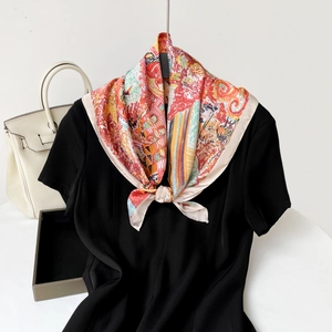 Detail of artistic floral oil painting silk scarf tied on a black dress neckline