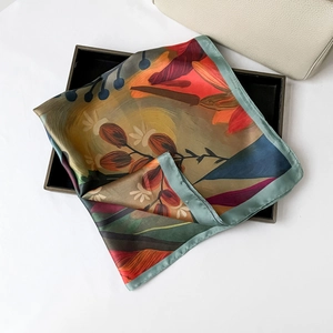 Close-up of floral oil painting silk scarf with elegant satin luster and fine edges
