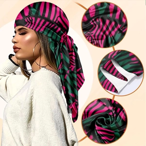 Pink and green zebra print silky square scarf shown on a model with fabric details