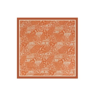 Detailed flat lay of an orange and white paisley print square satin chiffon scarf