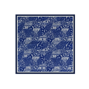 Detail of square satin scarf showing dark blue and white paisley patterns with silk texture