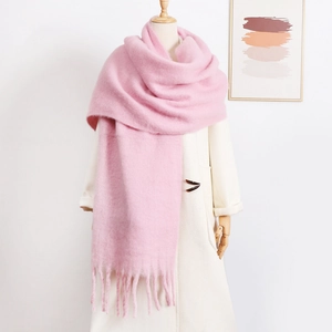Detailed view of pink mohair scarf with soft fluffy texture and long tassels