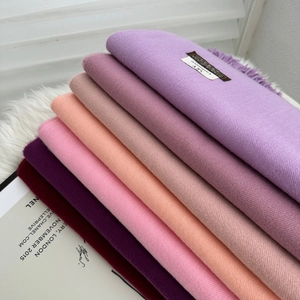 Warm solid cashmere shawls for women in purple and pink shades with tassel edges