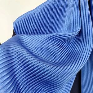 Macro detail of royal blue micro-pleated satin fabric with premium silk-like texture