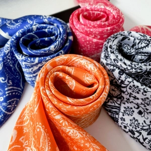 Silk-like satin square scarves featuring paisley floral prints in four vibrant colors
